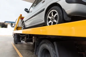 broken-car-on-flatbed-tow-truck-being-transported-2025-03-05-15-34-38-utc