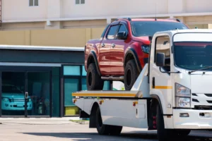 broken-red-pickup-car-loaded-onto-white-towing-tru-2025-03-11-16-34-09-utc
